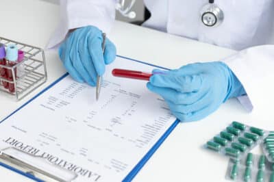 Doctor examining lab reports.